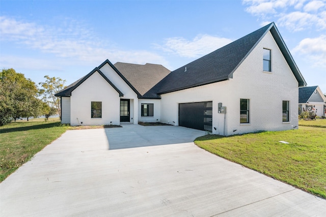 view of front of property with a garage and a front lawn