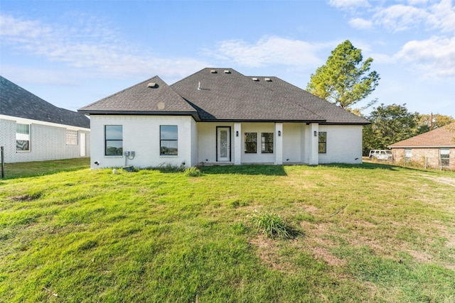 rear view of house with a yard