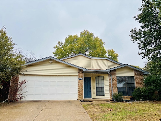 single story home featuring a garage and a front yard