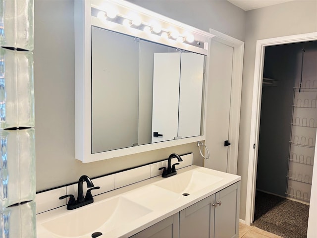 bathroom with tile patterned flooring and vanity