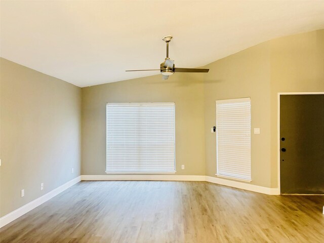 spare room featuring light hardwood / wood-style floors, ceiling fan, and lofted ceiling