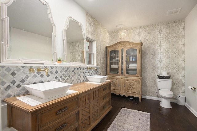 bathroom featuring vanity, toilet, and wood-type flooring