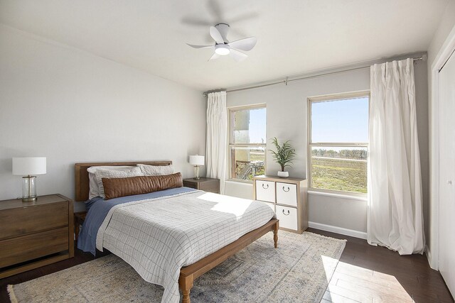 bedroom featuring ceiling fan and dark wood-type flooring