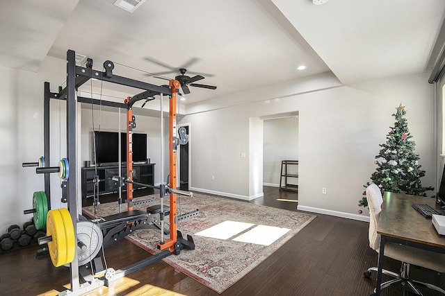 workout room with dark hardwood / wood-style floors and ceiling fan