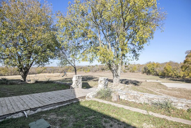 view of yard with a rural view