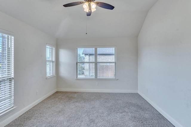 unfurnished room with light carpet, ceiling fan, and vaulted ceiling