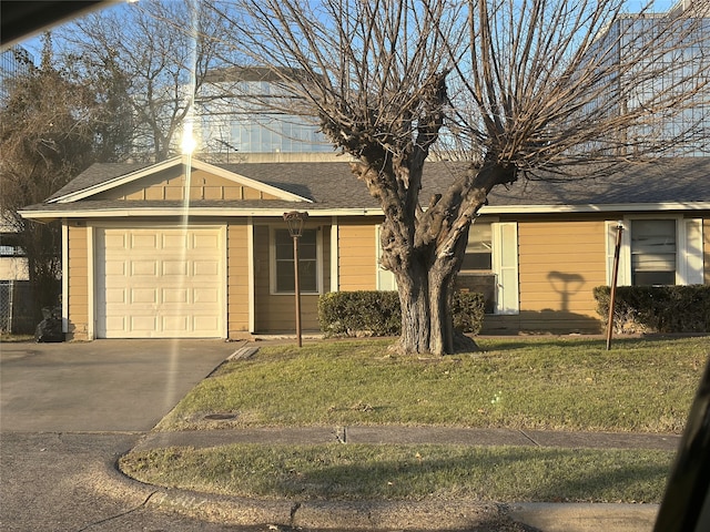 single story home with a garage and a front lawn