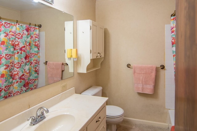 bathroom with toilet, vanity, and ornamental molding