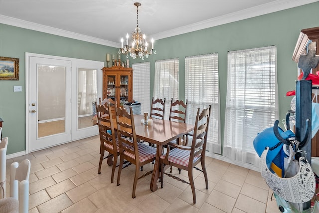 tiled dining room with a notable chandelier and ornamental molding