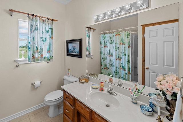 bathroom featuring tile patterned flooring, vanity, and toilet