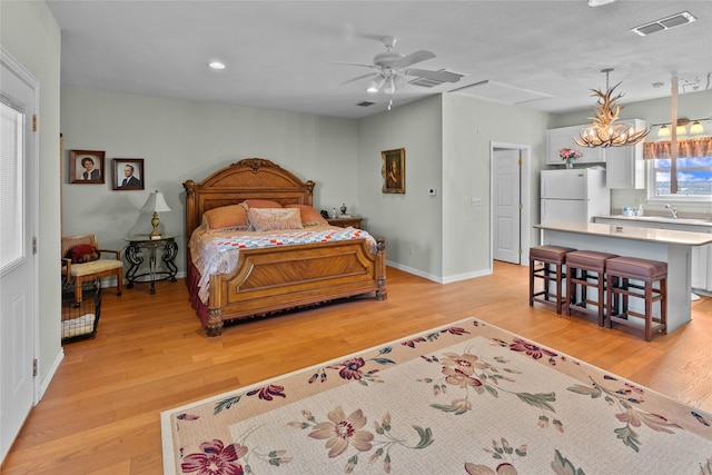 bedroom featuring white refrigerator and light hardwood / wood-style flooring