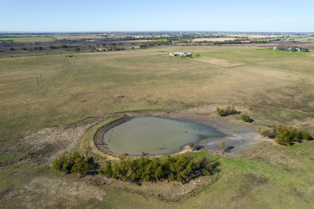 drone / aerial view featuring a water view and a rural view