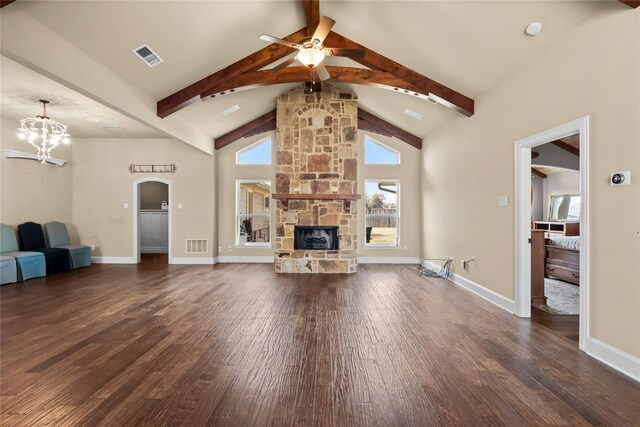 unfurnished living room with beam ceiling, dark hardwood / wood-style flooring, and a stone fireplace