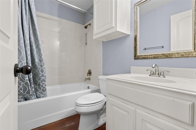 full bathroom with vanity, shower / bath combo with shower curtain, and toilet