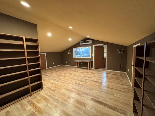 bonus room with vaulted ceiling and light hardwood / wood-style floors