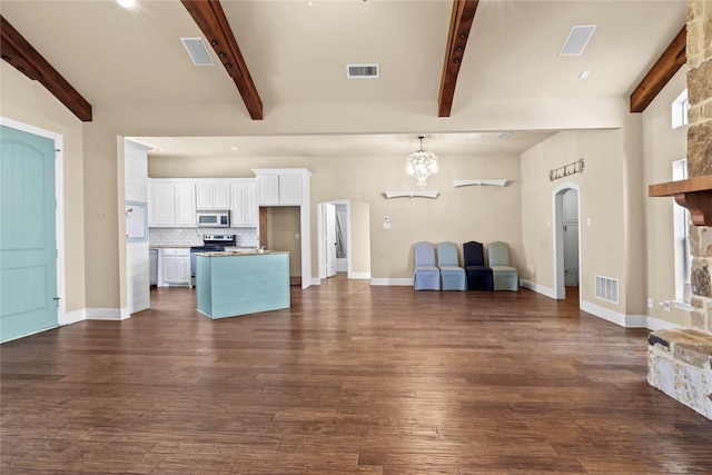 unfurnished living room with beamed ceiling, dark hardwood / wood-style floors, and a chandelier