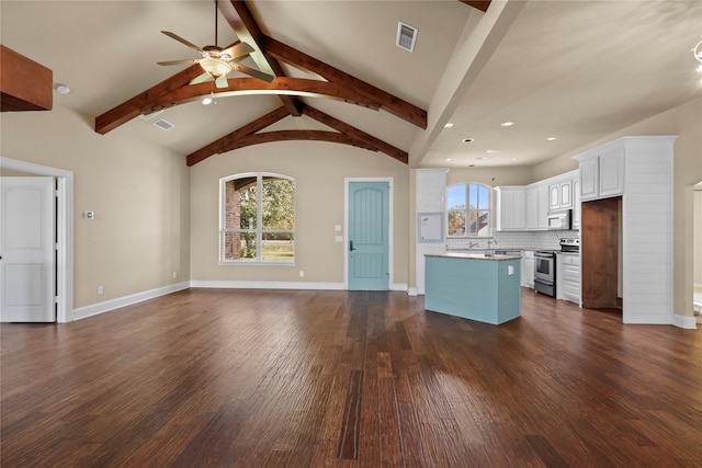 kitchen with plenty of natural light, stainless steel electric range oven, a center island, and white cabinets