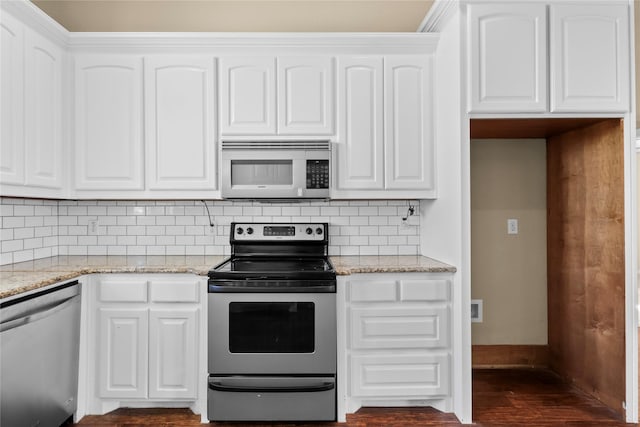 kitchen featuring light stone counters, stainless steel appliances, decorative backsplash, and white cabinets