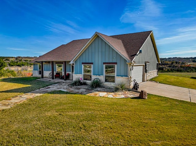 view of front facade featuring a garage, covered porch, and a front lawn