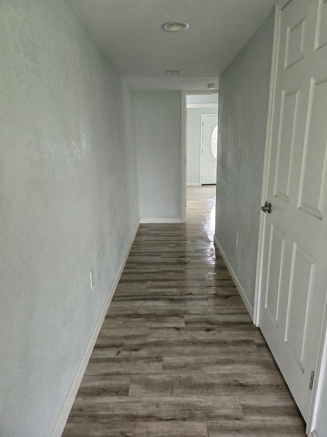 hallway featuring dark hardwood / wood-style flooring