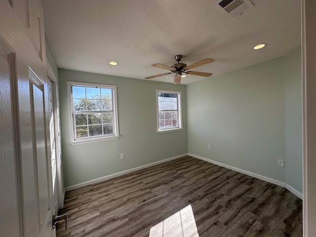 empty room featuring dark wood-type flooring and ceiling fan