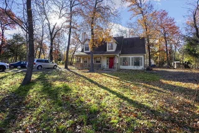 view of front of property with a front yard and a porch