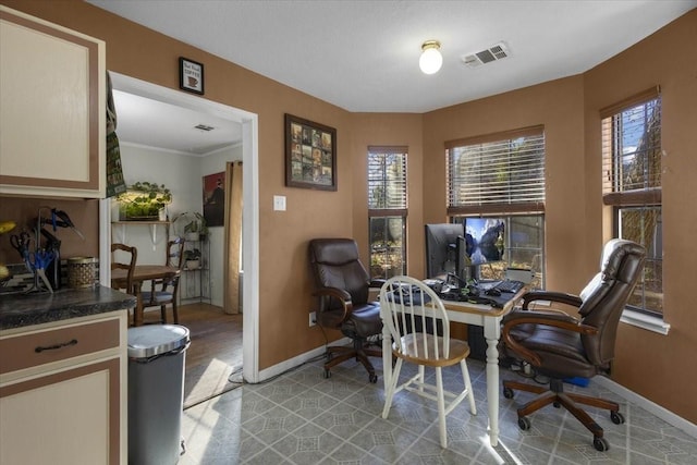 office space with ornamental molding, light hardwood / wood-style flooring, and a healthy amount of sunlight