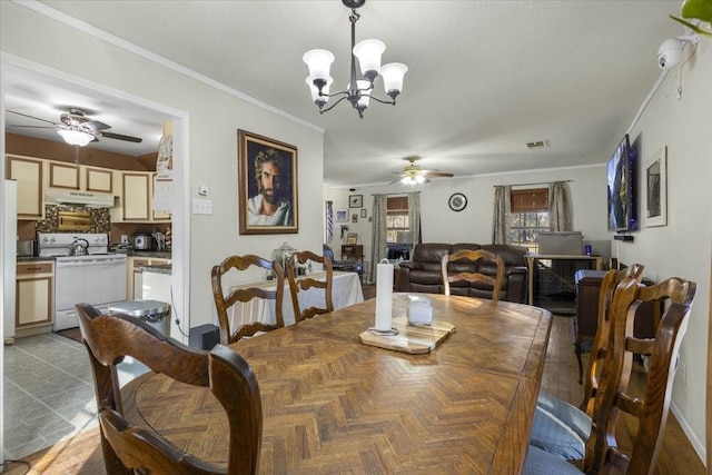 dining space featuring ceiling fan with notable chandelier and crown molding