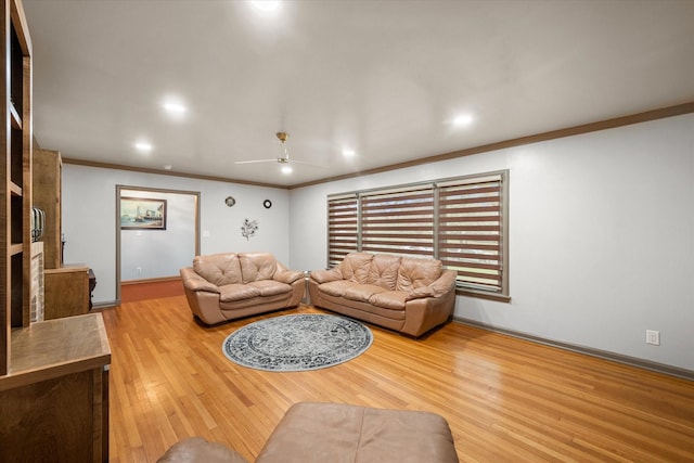 living room with ceiling fan, light wood-type flooring, and crown molding