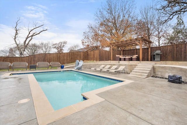 view of pool featuring a pergola, a patio area, a fenced backyard, a fenced in pool, and a water slide