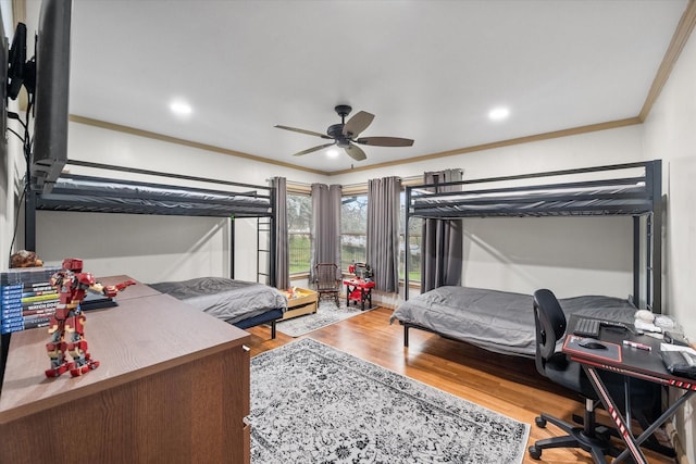 bedroom featuring ceiling fan, wood-type flooring, and ornamental molding