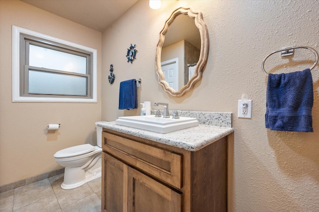 bathroom featuring toilet, vanity, and tile patterned floors