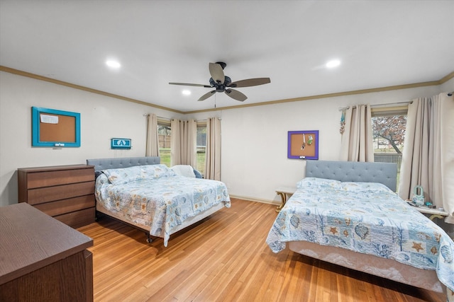 bedroom featuring light hardwood / wood-style flooring, ceiling fan, and ornamental molding