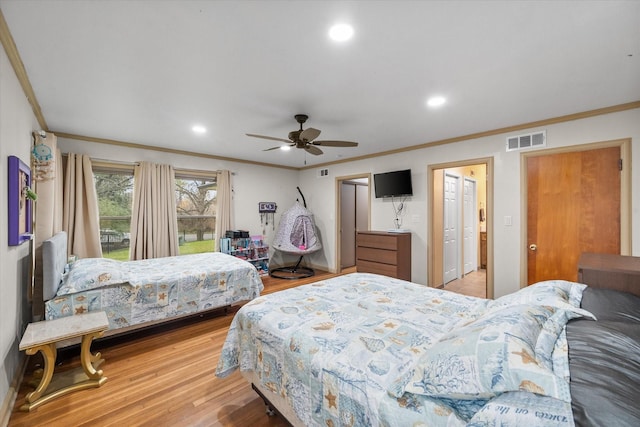 bedroom featuring ceiling fan, light wood-type flooring, and crown molding