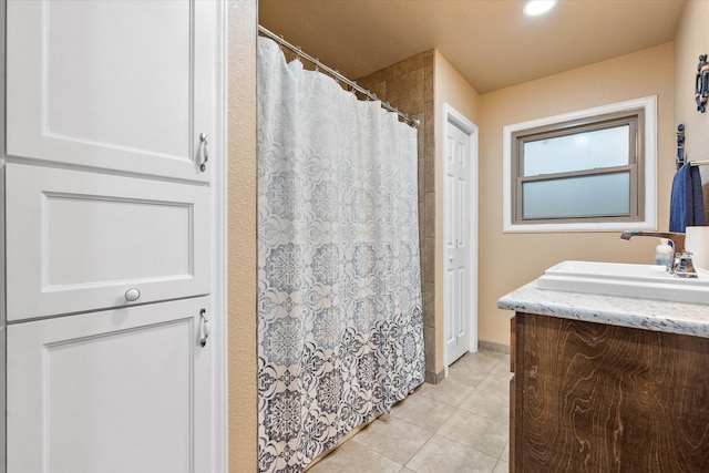 full bath with a shower with shower curtain, tile patterned flooring, and vanity