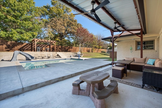 view of pool featuring an outdoor living space, a water slide, a pergola, ceiling fan, and a patio area