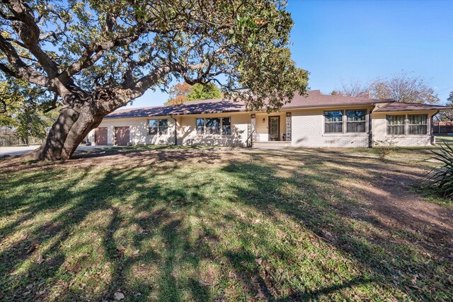 rear view of property featuring a lawn