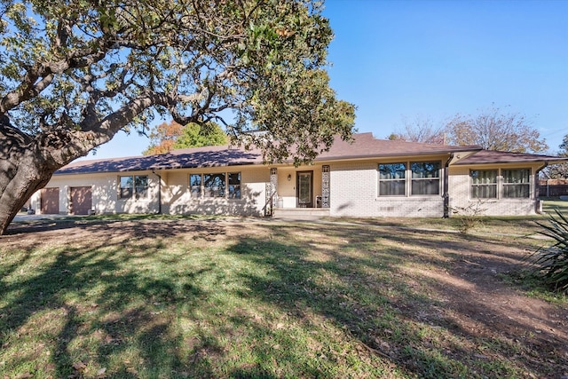 view of front of property with brick siding and a front yard