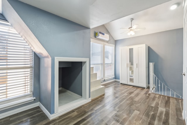 interior space with plenty of natural light, dark hardwood / wood-style floors, and an AC wall unit