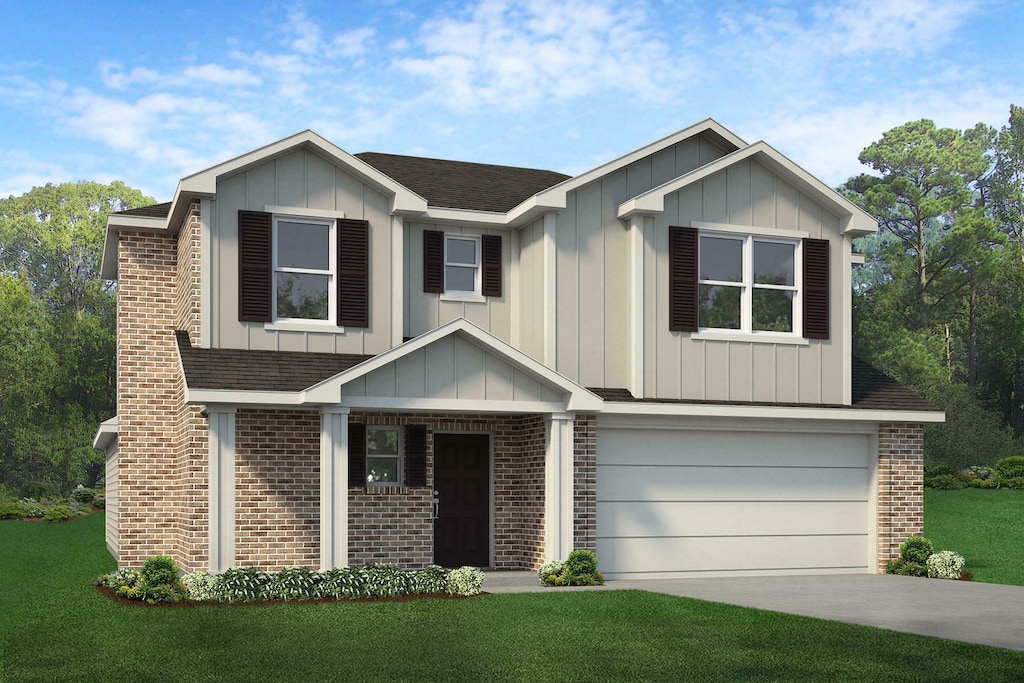 view of front of home with a garage and a front lawn