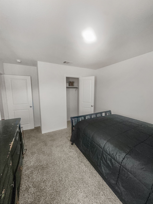 carpeted bedroom with a closet