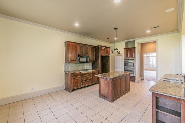 kitchen with light stone countertops, sink, decorative backsplash, appliances with stainless steel finishes, and ornamental molding