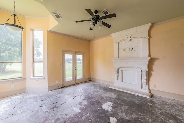 unfurnished living room with a tiled fireplace, crown molding, and ceiling fan