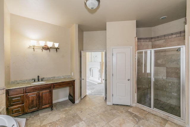 bathroom featuring a shower with door and vanity