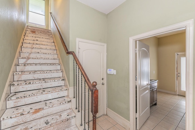 staircase featuring tile patterned floors