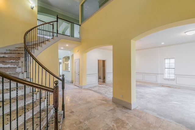 foyer featuring a high ceiling and ornamental molding