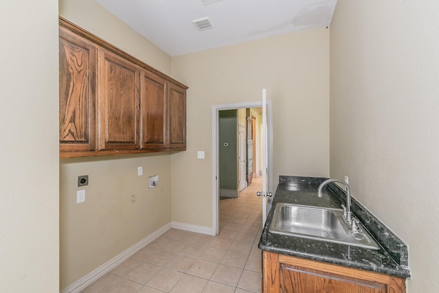 kitchen featuring dark stone countertops, sink, and light tile patterned floors