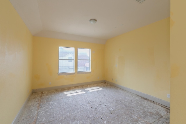 empty room with lofted ceiling