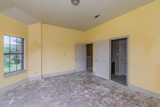 unfurnished bedroom featuring lofted ceiling