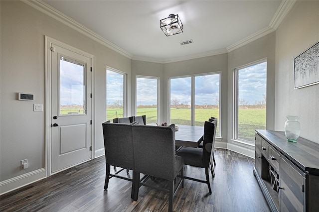 dining area featuring dark hardwood / wood-style flooring and ornamental molding